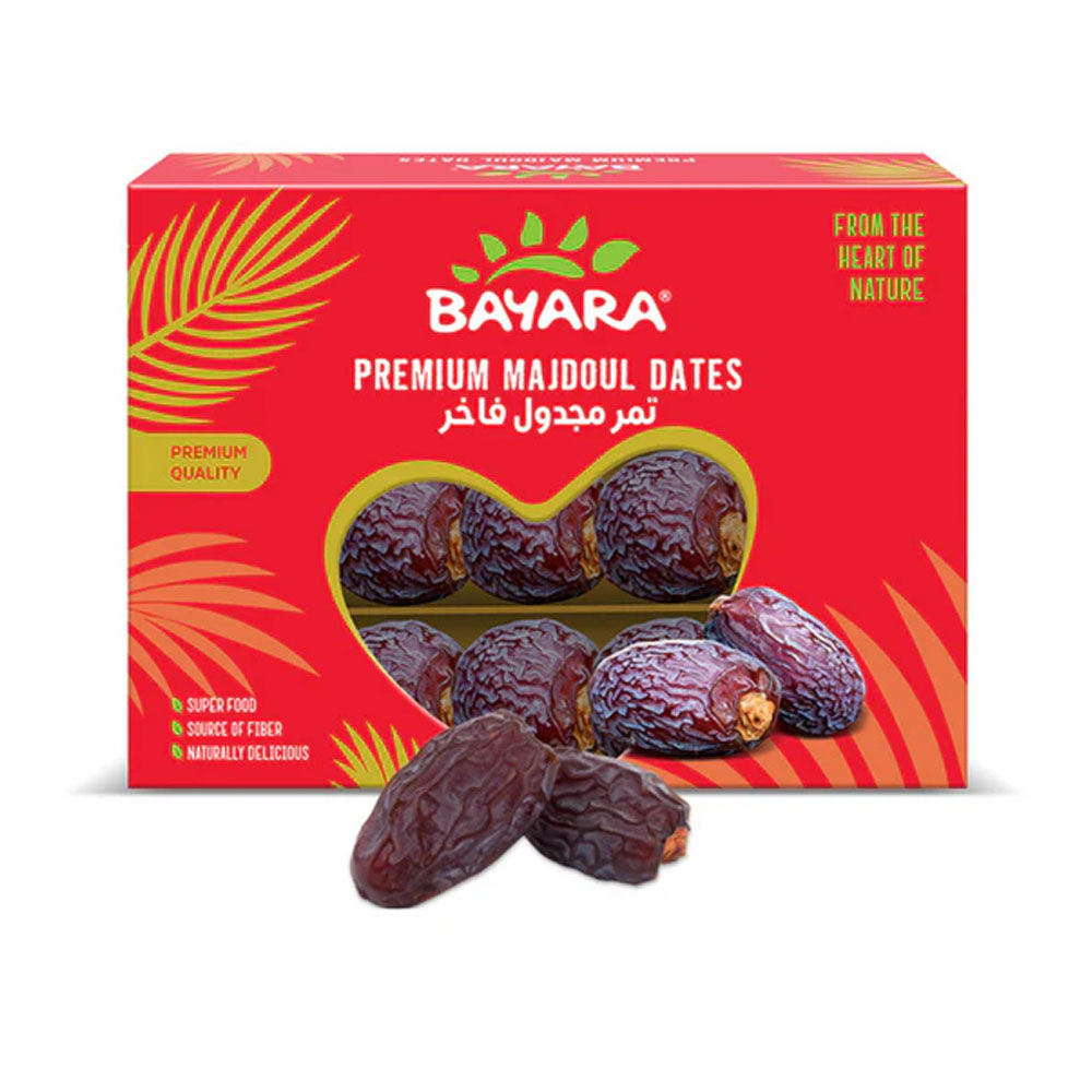 Dates Majdoul 500g A red 500g box of Bayara Premium Majdoul Dates showing large, dark brown dates through a heart-shaped window.
