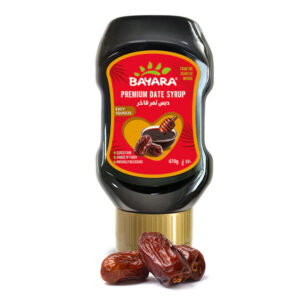 A 470g black squeezable bottle of Bayara Premium Date Syrup with a gold cap and red label.