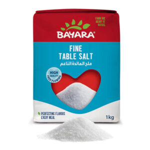 A 1kg blue and red pack of Bayara Fine Table Salt showing clean white salt through a heart-shaped window.