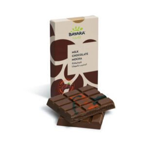 A 100g box of Bayara Milk Chocolate Mocha sitting behind two pieces of broken filled chocolate bar.