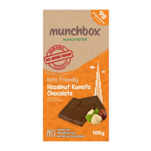 A 100g bar of Munchbox Keto Friendly Hazelnut Kunafa Chocolate showing chocolate squares and roasted hazelnuts.