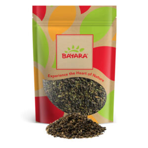 A 100g colorful pouch of Bayara Moroccan Tea showing high-quality dried green tea leaves through a window.