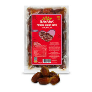 A 1kg vacuum-sealed transparent pack of Bayara Premium Khalas Dates with a red and pink label.